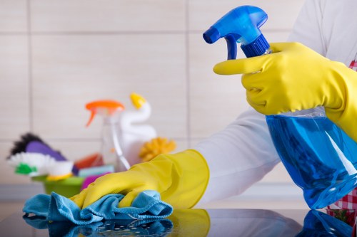 Office cleaners sanitising desks and shared surfaces in Barnet