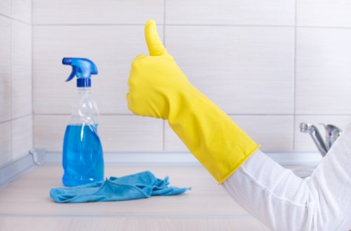 Cleaning team following safe chemical handling and protective equipment procedures